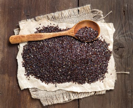 Psyllium seeds with a spoon on a craft paper