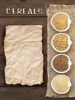 Cereals in bowls with word Cereals on wooden background