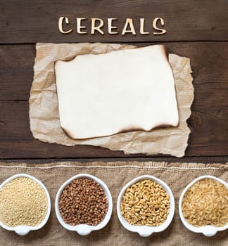 Cereals in bowls with word Cereals and paper on wooden background