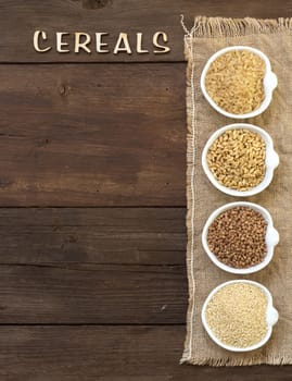 Cereals in bowls border with word Cereals on wood