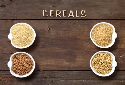 Cereals in bowls border with word Cereals on wood