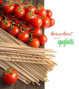 Spaghetti and tomatoes on old vintage wooden table