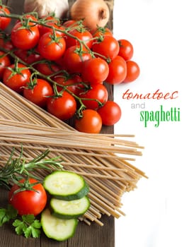 Spaghett, herbs, zucchinii and tomatoes on the old wooden tale