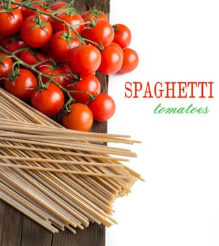 Spaghetti and tomatoes on old vintage wooden table
