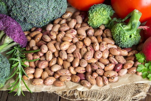 Pinto beans and vegatables on the old wooden table