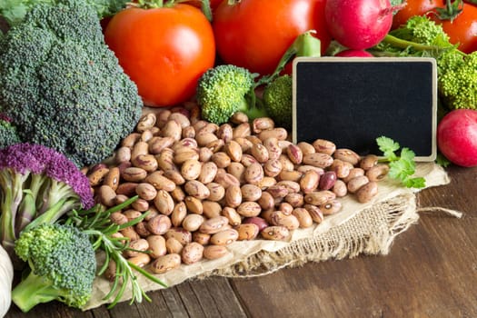 Pinto beans and vegatables on the old wooden table