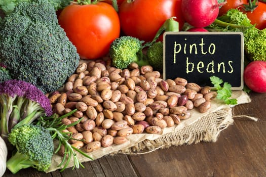 Pinto beans and vegatables on the old wooden table