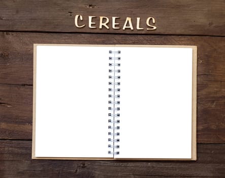 The word of Cereals with notebook on wood