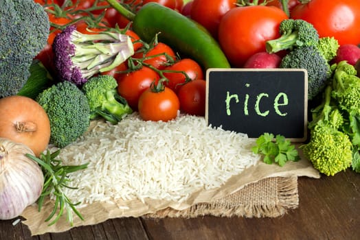 Basmati rice and vegatables on the old wooden table