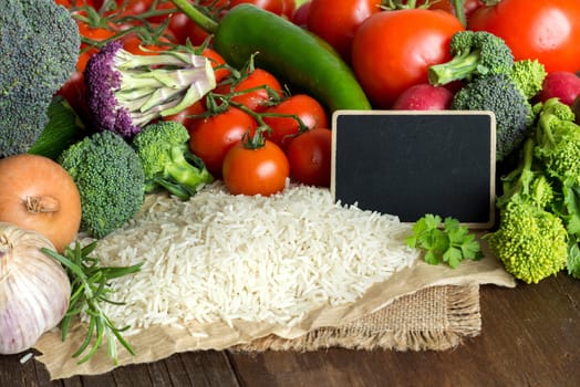 Basmati rice and vegatables on the old wooden table