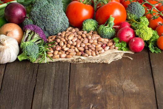 Pinto beans and vegatables on the old wooden table