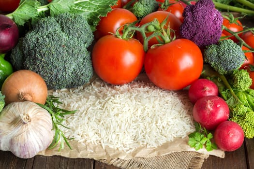 Pile of Basmati rice and vegetables on wood