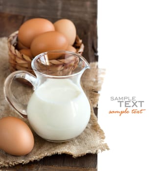 Chicken eggs and milk on the old wooden table