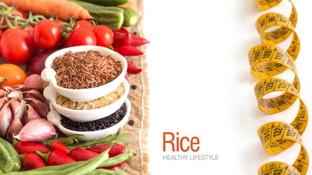 Red, black and unpolished organic rice in bowls and vegetables