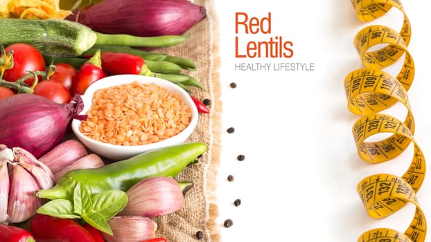 Red lentils in bowl and vegetables isolated on white