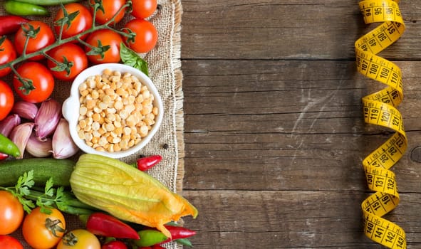 Raw Organic yellow peas in bowl and vegetables