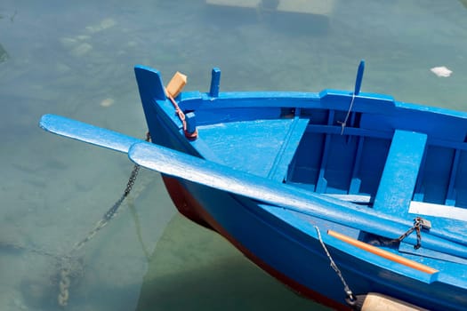 Blue and red fishing boats in harbour, south Italy