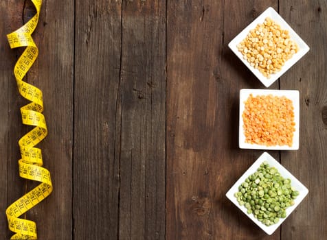 Legumes in bowls on a wooden table