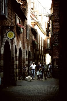 Bremen,Germany - August 30,2016: Pedestrians with dogs walk through the narrow and well-known Böttcher Straße with shops and shops on August 30,2016 in Bremen.