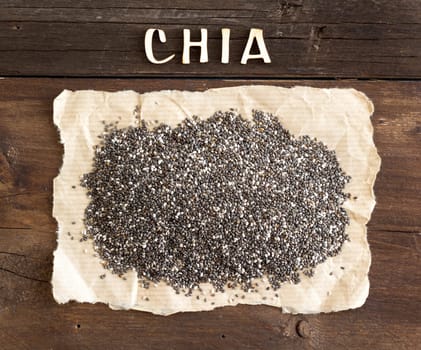 Chia seeds with a word CHIA on wooden background