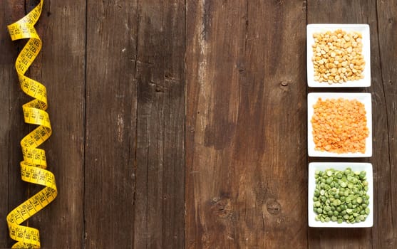 Legumes in bowls on a wooden table
