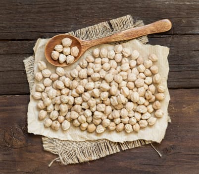 Chickpea with a spoon on a wooden table