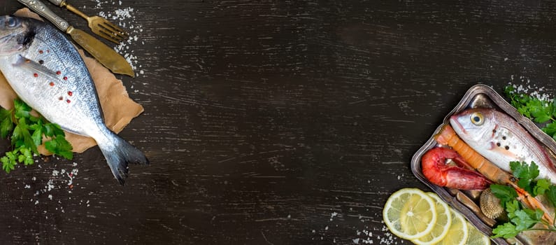 Fresh fish and seafood on a dark vintage background