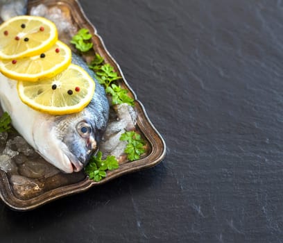 Fresh dorado fish on ice on vintage silver tray