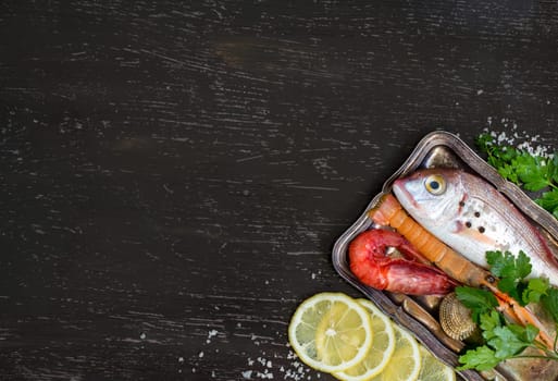 Fresh fish and seafood on a dark vintage background