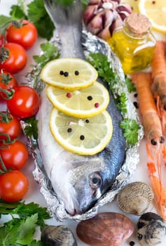 Fresh dorado fish, vegetables, olive oil and seafood