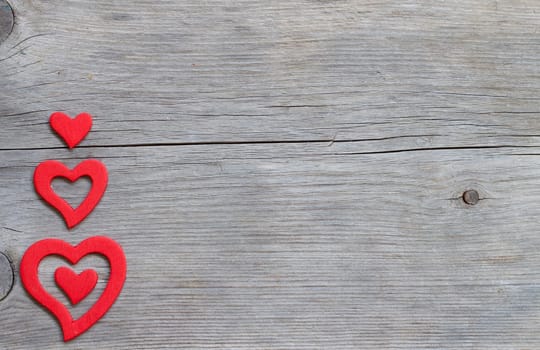 Red hearts on a old wooden background