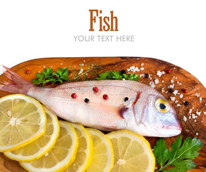 Fresh fish with lemon on a wooden board isolated on white