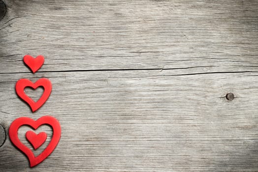 Red hearts on wood - retro background