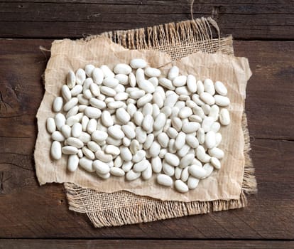 Pile of White beans on a wooden bacground