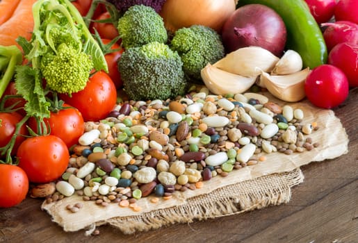 Mixed legumes and vegetables on a wooden table