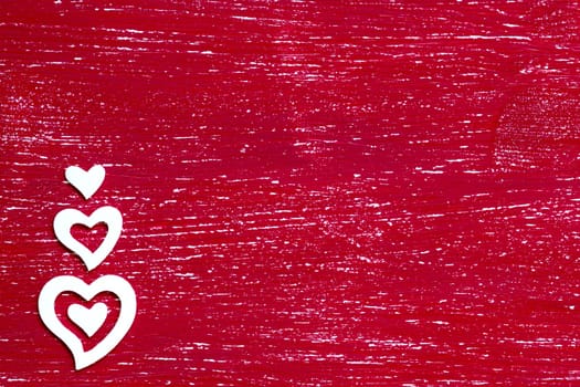 White hearts on a red shabby background