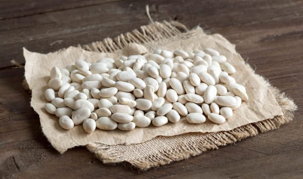 Pile of White beans on a wooden bacground