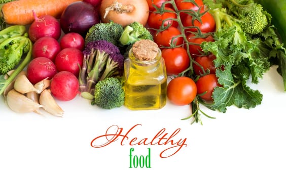 Vegetables and a bottle of olive oil isolated on white