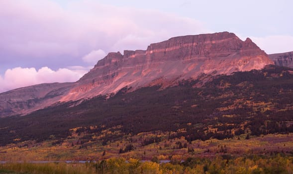 Fall color and sunrise comes to the mountains of East Glacier Montana