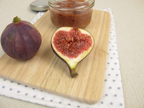 Homemade fig jam in a glass and fresh figs