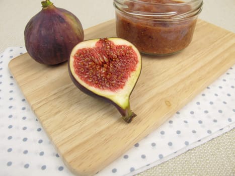 Homemade fig jam in a glass and fresh figs
