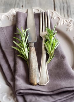 Vintage Table setting with rosemary decor close up