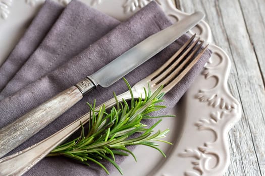 Vintage Table setting with rosemary decor close up