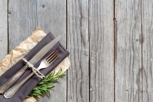 Vintage Table setting with rosemary decor on old wooden table