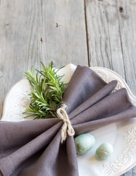 Easter table setting with eggs and rosemary