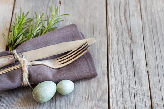 Easter table setting with eggs and rosemary
