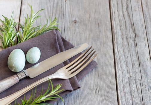 Easter table setting with eggs and rosemary