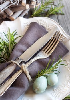 Easter table setting with eggs and rosemary