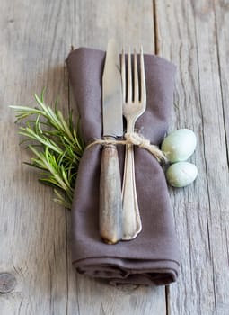 Easter table setting with eggs and rosemary