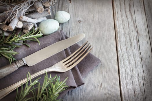 Easter table setting with eggs and rosemary